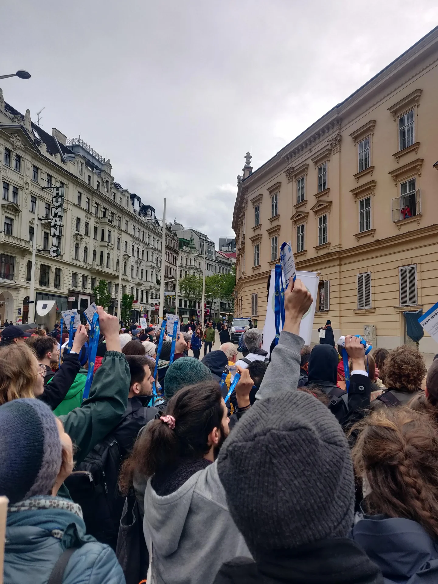 EGU scientists holding up their badges at a climate protest 2