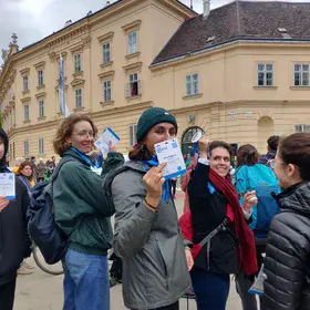 EGU scientists holding up their badges at a climate protest 3