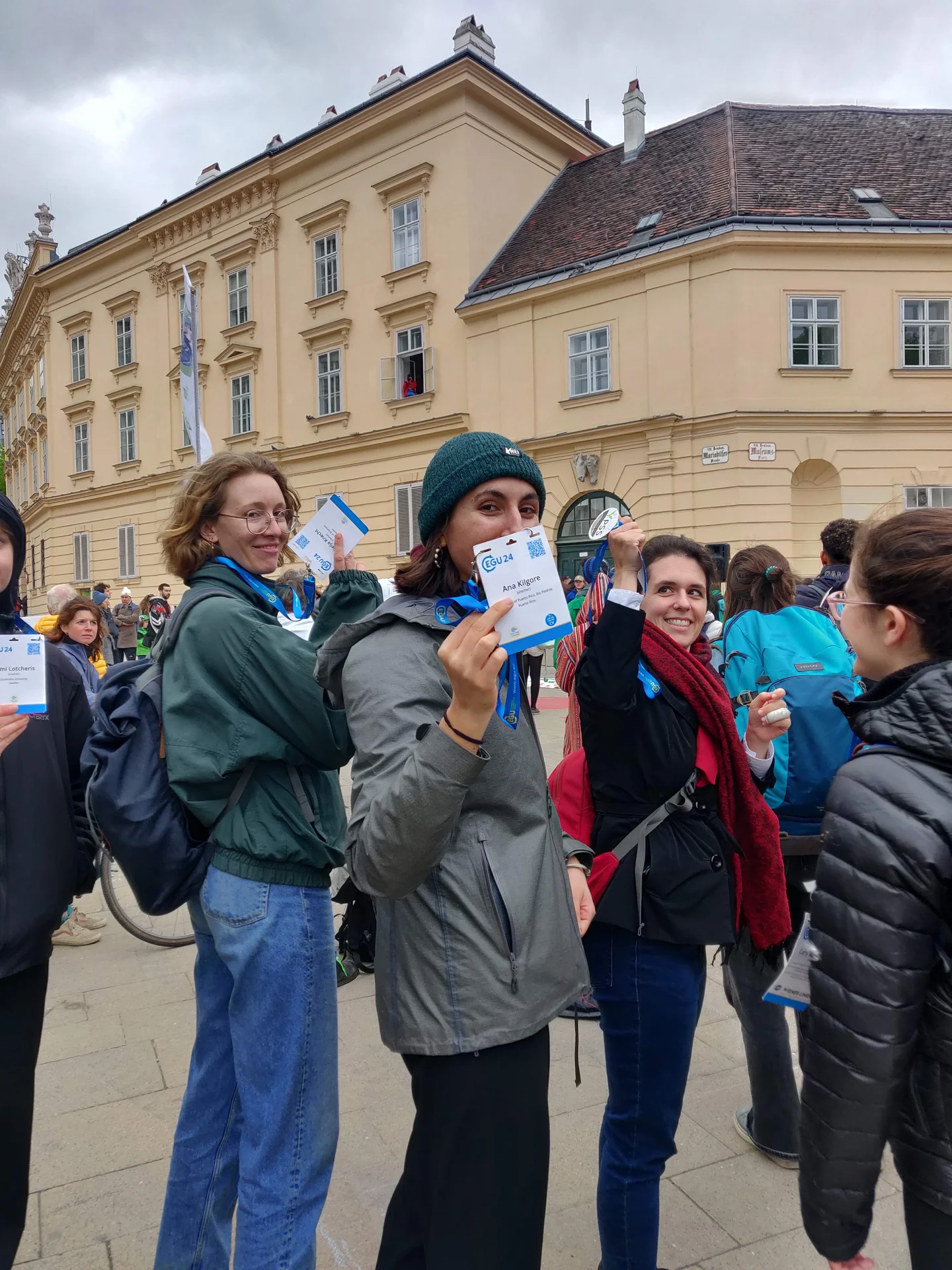 EGU scientists holding up their badges at a climate protest 3