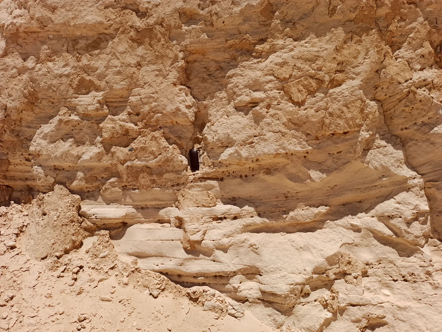 An Original Outcrop of Sedimentary Bedding with Weathering Gaps and Holes