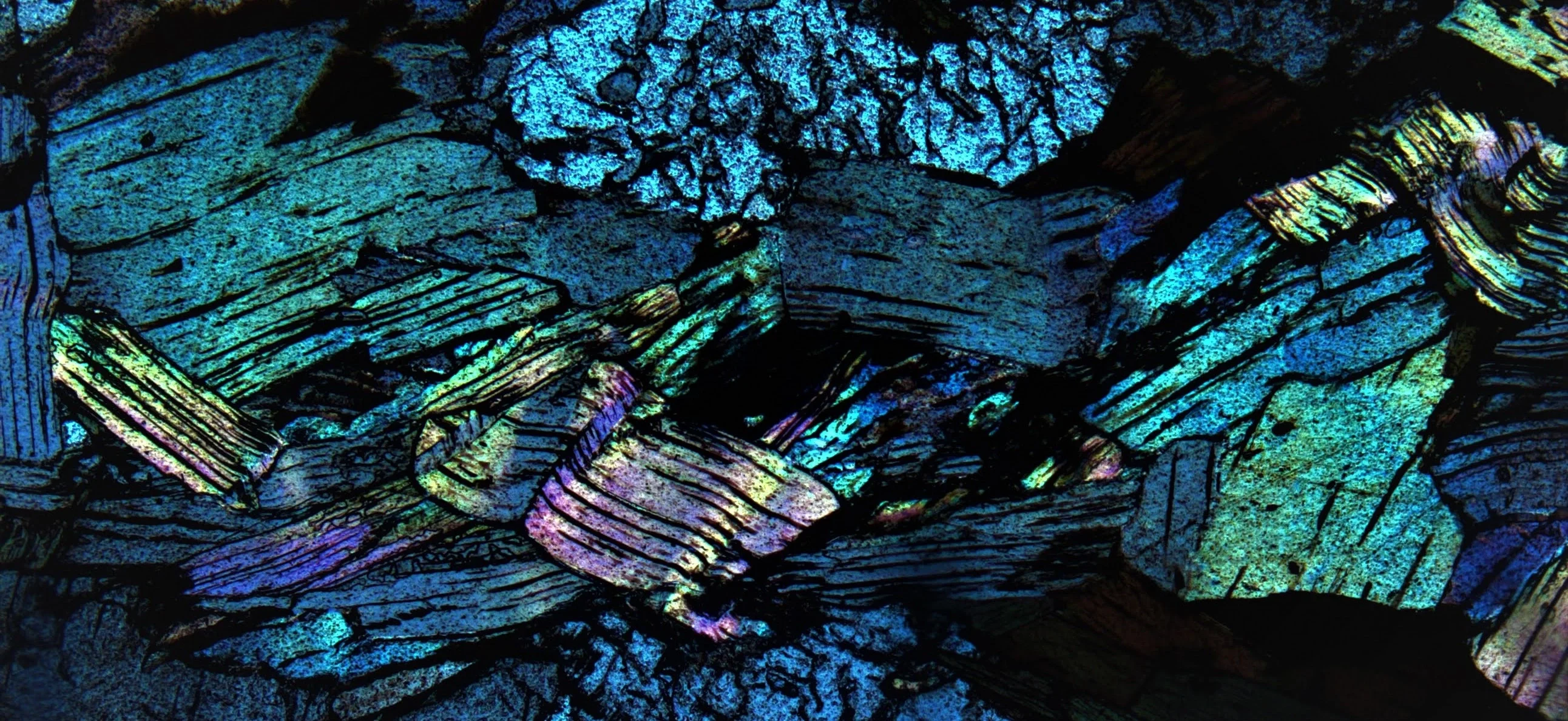 Folded muscovite layers in XPL view from the Norra Kärr complex, Sweden.
