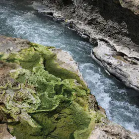 Quse hot spring, surrounded by green travertine, in Xizang (Tibet)