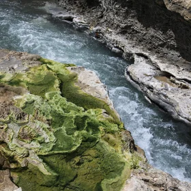 Quse hot spring, surrounded by green travertine, in Xizang (Tibet)