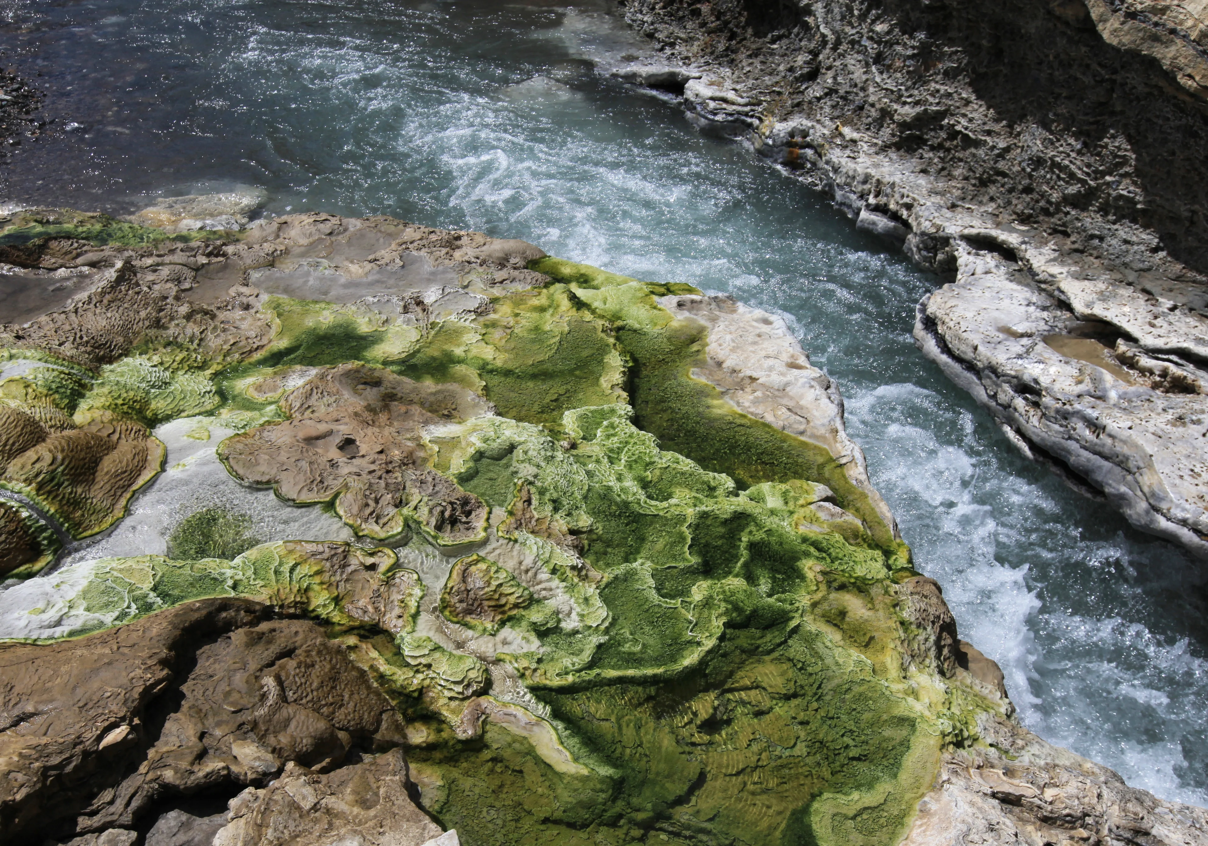 Quse hot spring, surrounded by green travertine, in Xizang (Tibet)